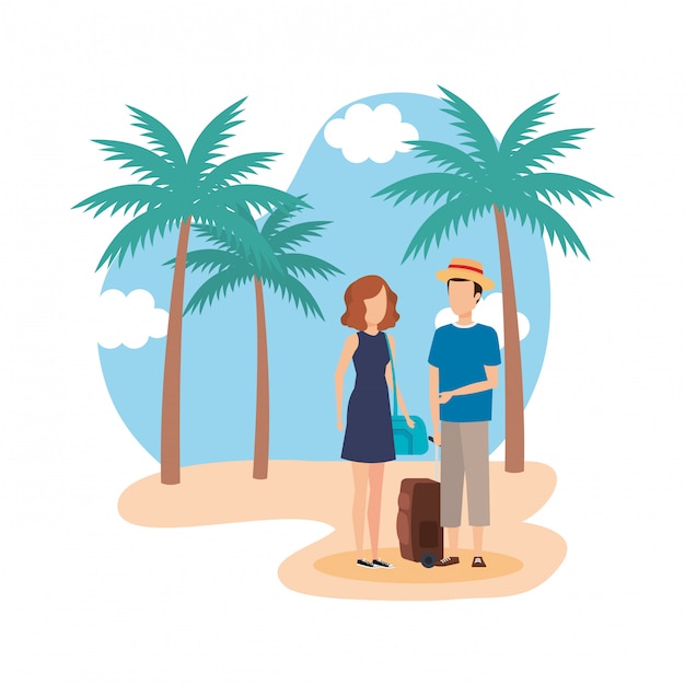 Young couple with suitcase on the beach