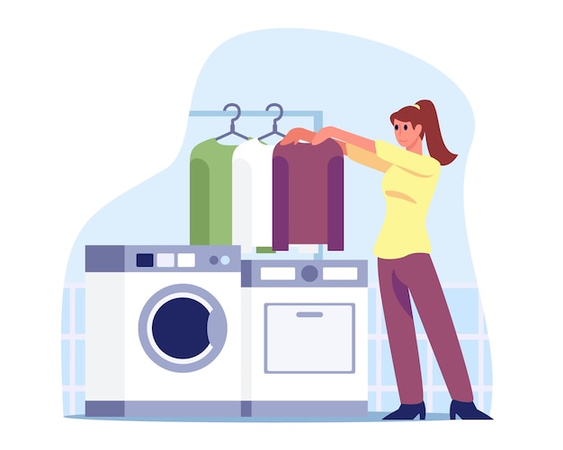 Young female standing near washing machine and holding clothes