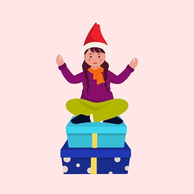 분홍색 Backgrouund에 선물 상자에 앉아 산타 모자를 쓰고 어린 소녀