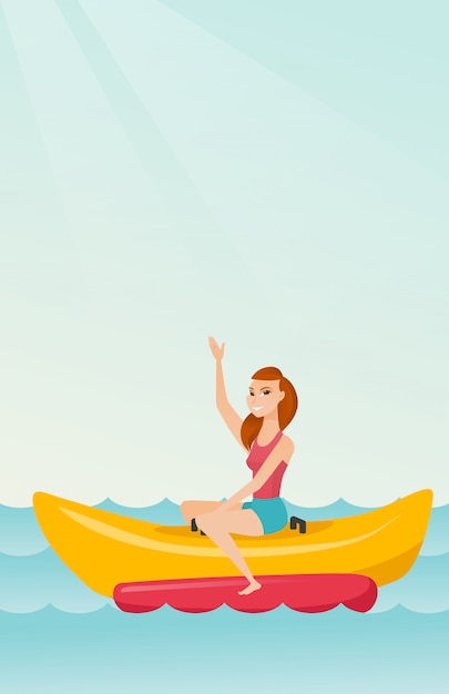 Young happy caucasian woman riding a banana boat