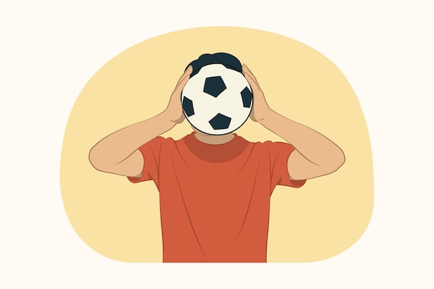 Young man covering face with soccer ball 