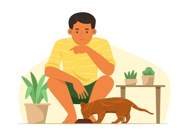 Young man feeding cat and looking