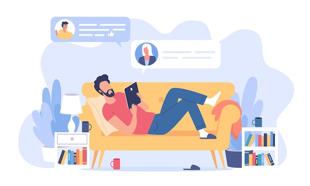 young man lying on the yellow sofa and sending some messages