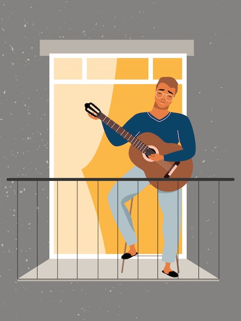 Young man plays guitar at the balcony. quarantine and self-isolation concept. staying at home during the pandemic. man in the window learning how to play guitar. guitar lessons at home.