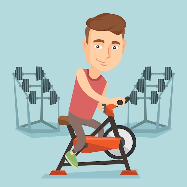 Young man riding stationary bicycle.