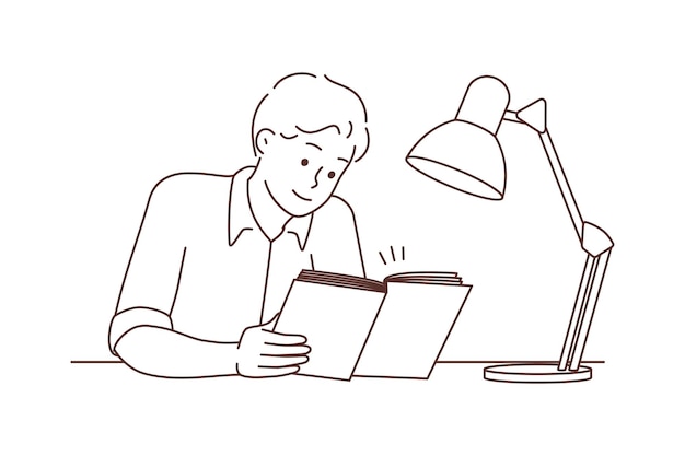 Young man sit at desk reading book