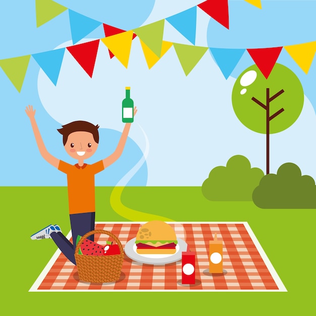 young man on tablecloth picnic food in the park 