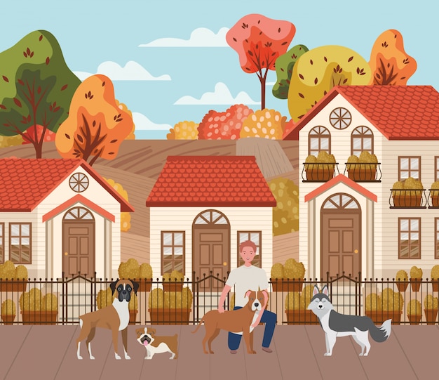 Young man with cute dogs mascots in the autumn city scene