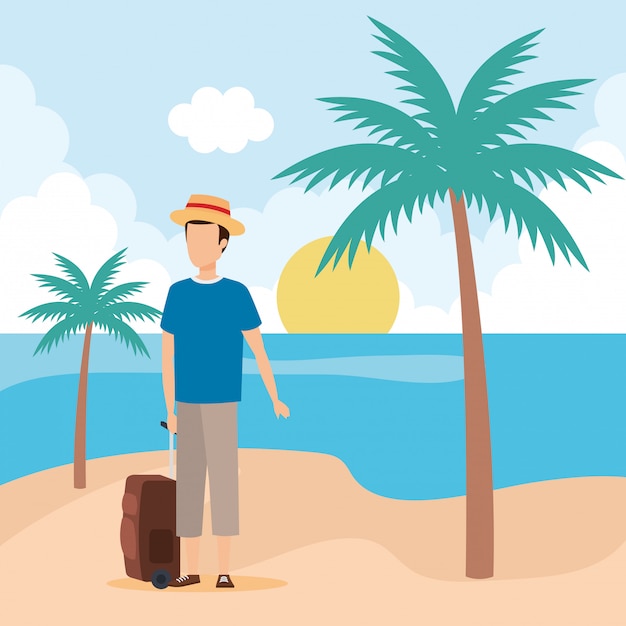 Молодой человек с чемоданом на пляже