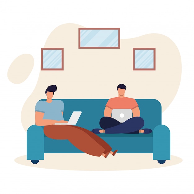 Young men using laptops and working in the livingroom