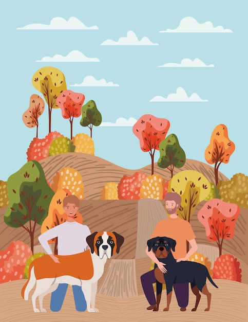 I giovani con simpatici cani mascotte in autunno campo