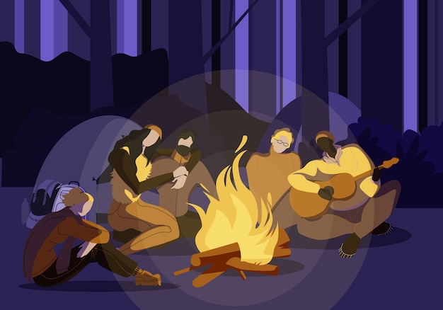 Young people sitting around campfire at night time