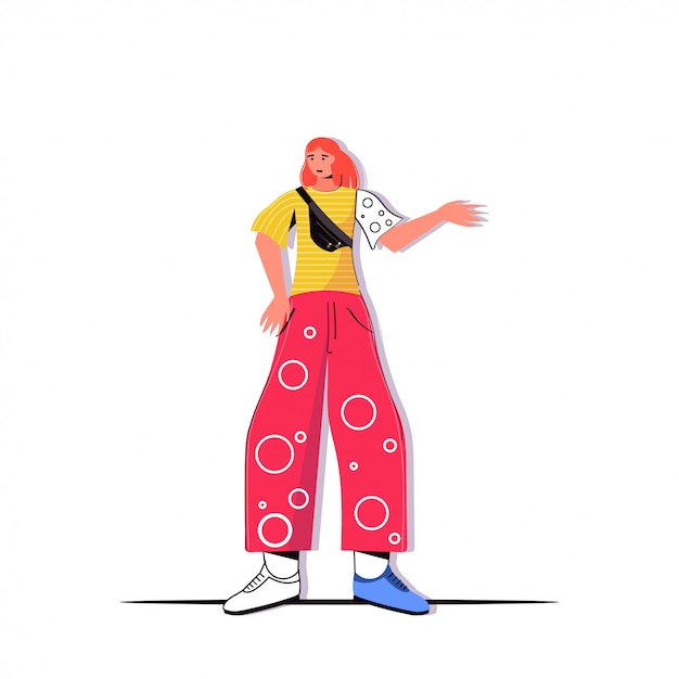 Giovane donna in abiti casual alla moda che punta la mano su qualcosa di femminile personaggio dei cartoni animati in piedi posev