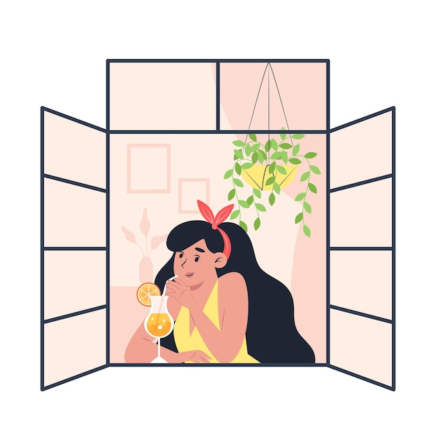 Young woman drinking cocktail at open window at home