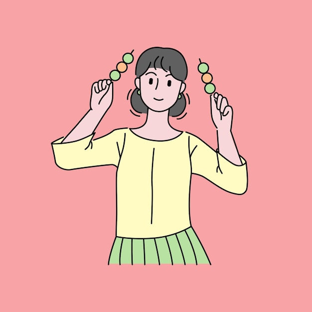 Молодая женщина ест шарики данго японской китайской уличной еды