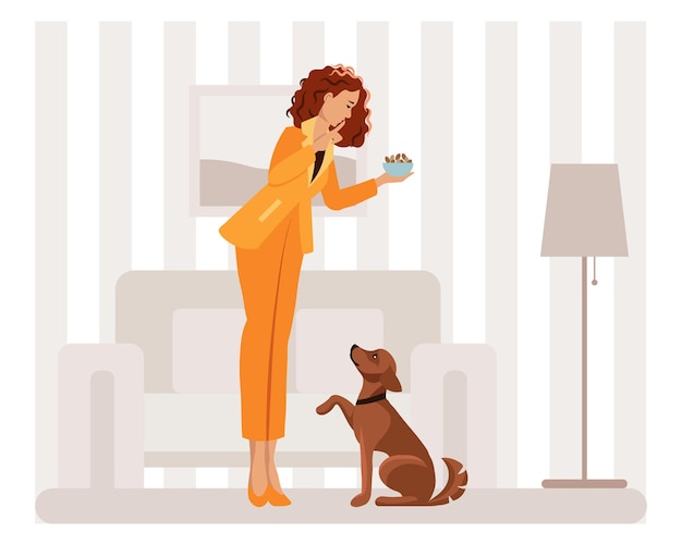 A young woman feeds and educates her dog the mistress and her pet in the home interior