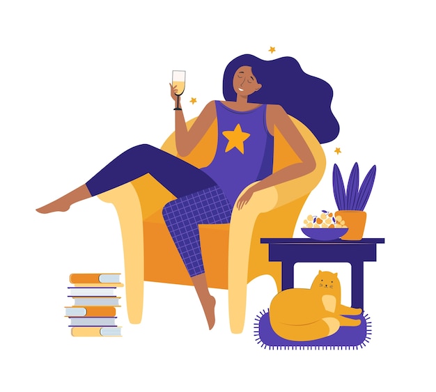 Young woman  at home. Girl in comfortable pajamas resting comfortably sitting on the big yellow chair and drinking wine.
