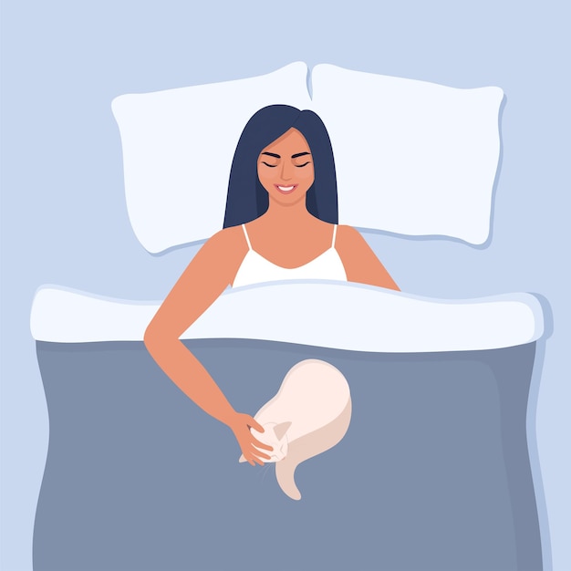 Young woman is lying in bed with a cat smiling and stroking him