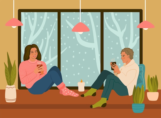 Young woman and man talking, drinking and spending time together. Cozy winter evening, Hygge life..