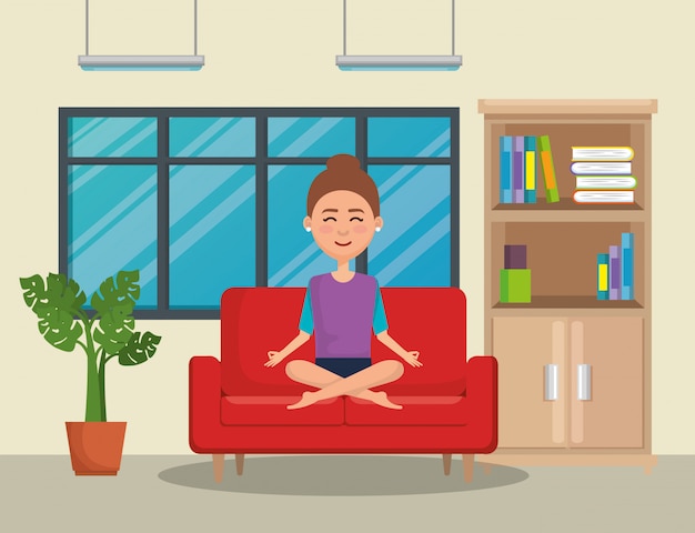 Young woman practicing yoga in the sofa