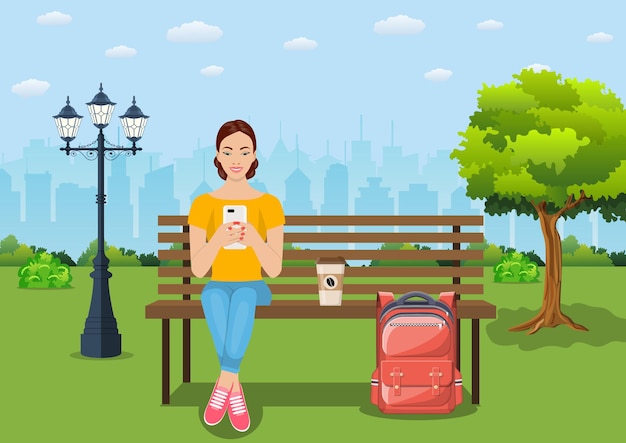 Young woman relaxing on bench with smartphone at park