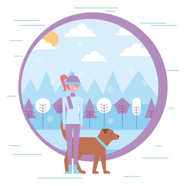 Giovane donna che cammina con il cane nel paesaggio invernale