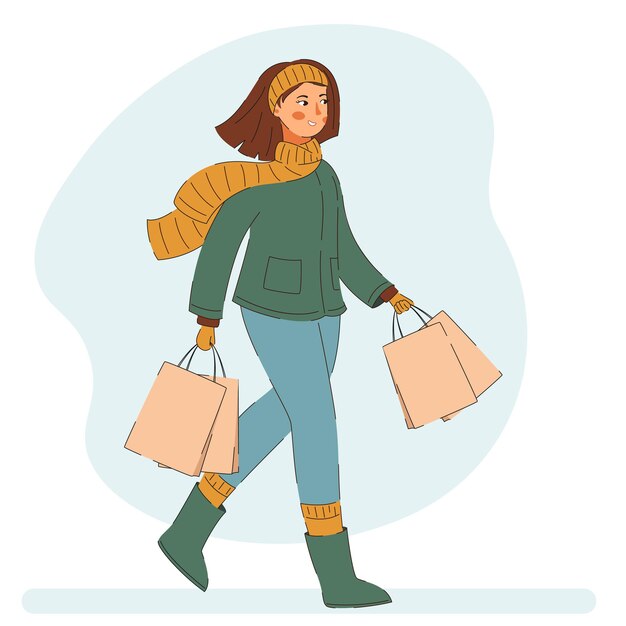 買い物袋を持って歩く若い女性。冬