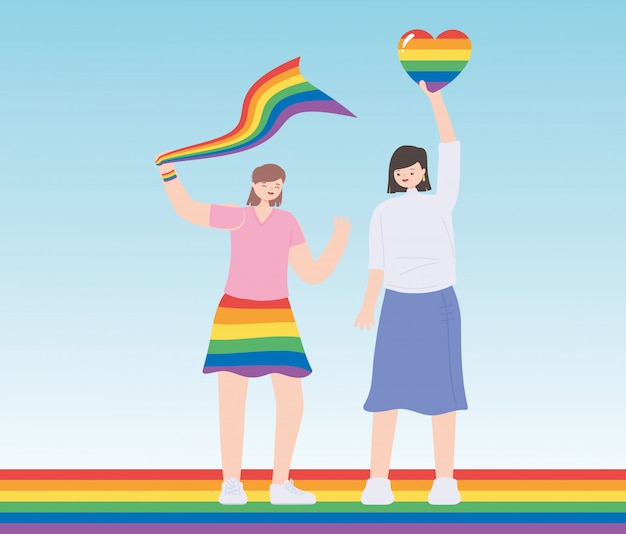 Young women holding rainbow heart and flag