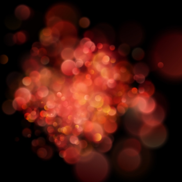 Abstract defocused circular red bokeh on dark background.