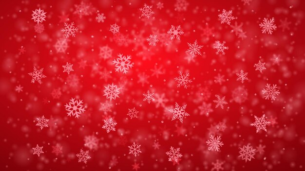 christmas background of complex blurred and clear falling snowflakes in red colors with bokeh effect