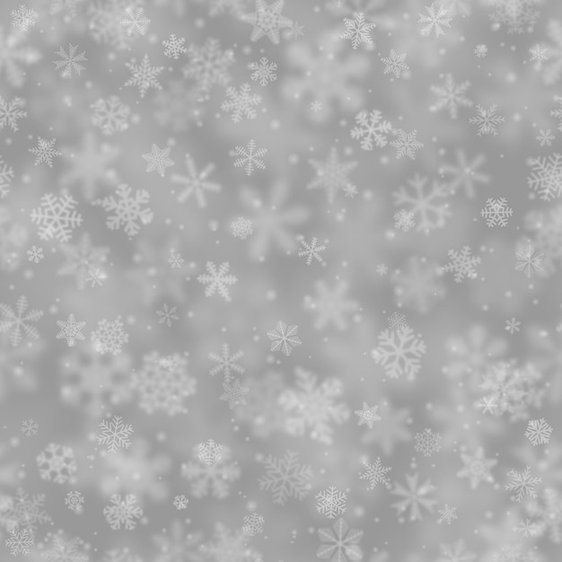 Gri arka planda farklı şekil boyut bulanıklığı ve şeffaflıktaki kar tanelerinin Noel deseni