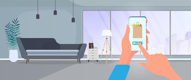 Order food and products over the phone. Order food at home. Food, hand holds a smartphone.