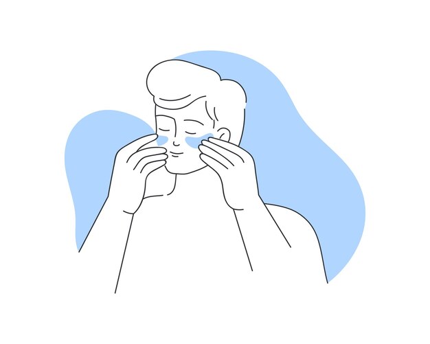 young man applying moisturizing patches to skin under eyes for hydration