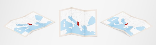 Folded map of Albania in three different versions.