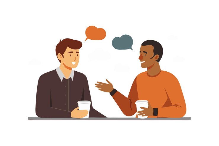 Two Men Engaged in a Friendly Conversation While Drinking Coffee