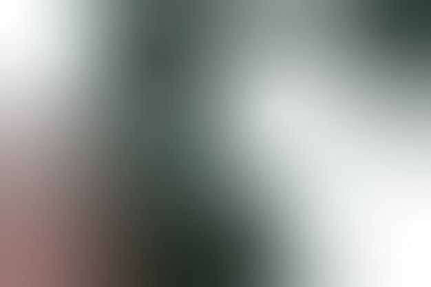 a close up of a silver colored background with a green and white light