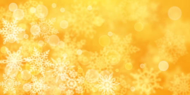Christmas background of blurry snowflakes in yellow colors
