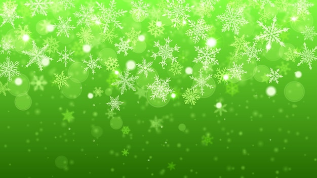Christmas background of complex blurred and clear falling snowflakes in green colors with bokeh effect