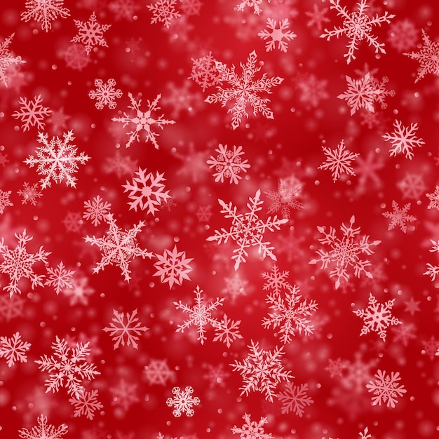 Christmas seamless pattern of complex blurred and clear falling snowflakes in red colors with bokeh effect
