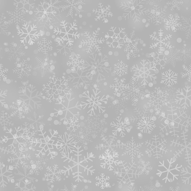 christmas seamless pattern of snowflakes of different shapes sizes and transparency on gray background