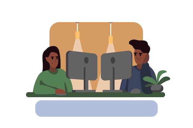 Male and female sitting near and working together on computers