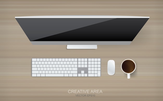 Top view of computer on wood background.
