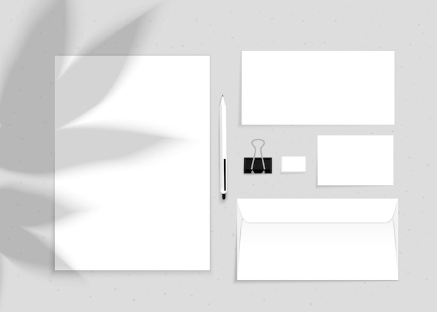 Vector mockup of office stationery with plant shadow on a gray background Pen A4 sheet scissors