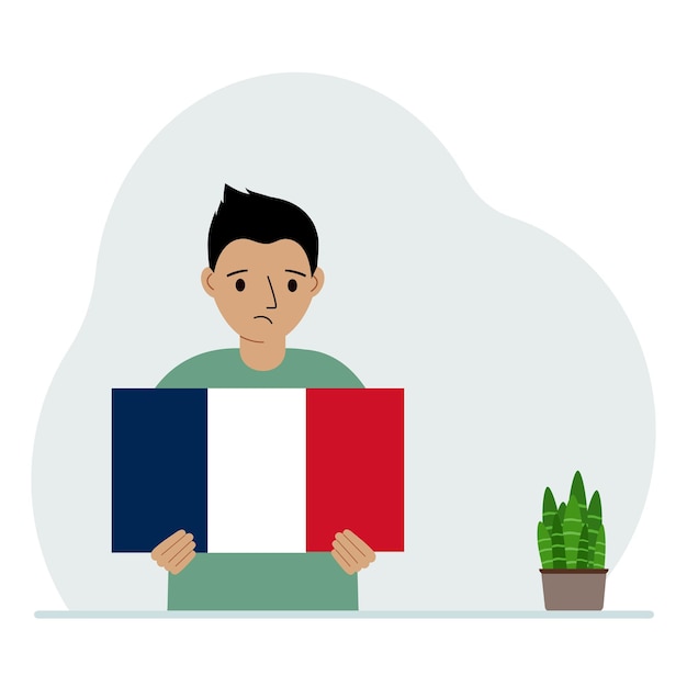 Mały chłopiec trzyma w rękach flagę Francji Koncepcja demonstracyjnego święta narodowego lub patriotyzmu Narodowość