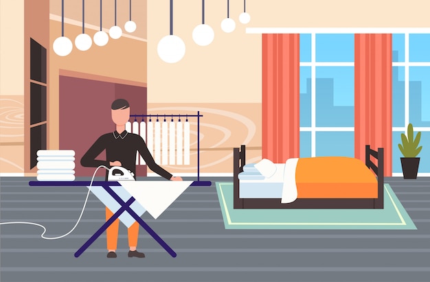 mężczyzna prasowanie ubrania facet za pomocą żelaza robi prace domowe koncepcja nowoczesnej sypialni wnętrze mężczyzna postać z kreskówki pełnej długości poziomej