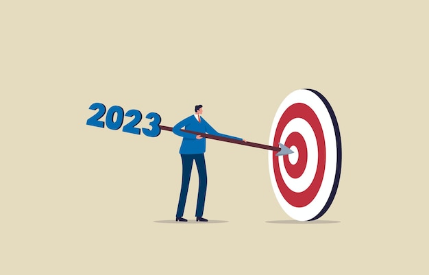 Osiągnij cele biznesowe w 2023 r., dąż do sukcesu biznesowego Biznesmen trzymający rzutkę celującą w cel w dziesiątkę