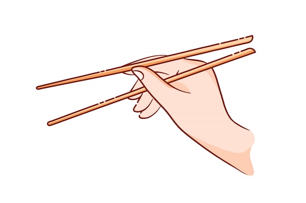 Ręka trzyma drewniane patyczki do sushi i bułki.