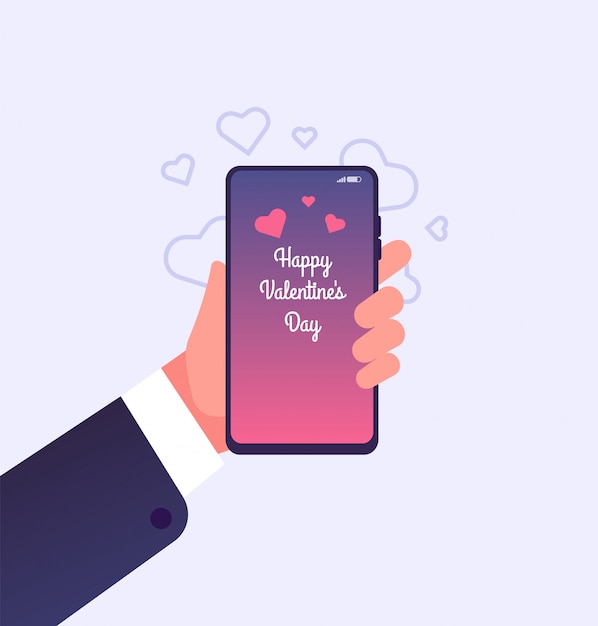 Ręka trzyma smartphone z szczęśliwy Walentynki gratulacje na ekranie
