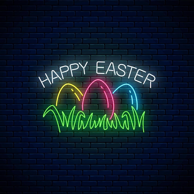 Wesołych świąt Wielkanocnych świecący Szyld Z Kolorowymi Jajkami Na Trawie W Neonowym Stylu Na Tle Ciemnego Ceglanego Muru.