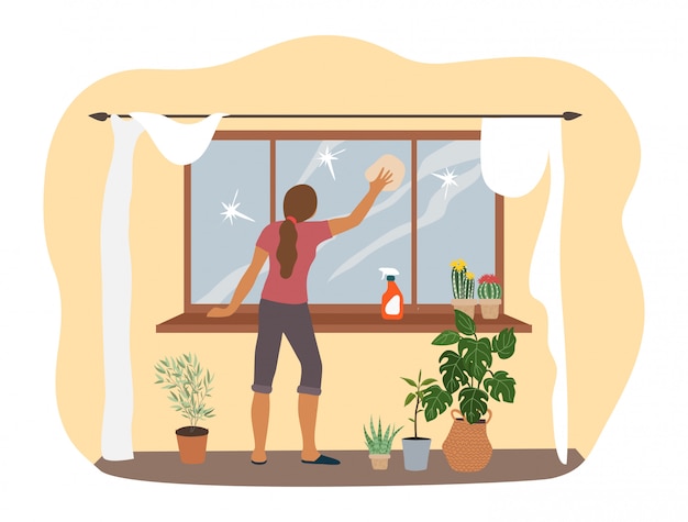 Wiosenne porządki w domu, kobieta myje okno w mieszkaniu.